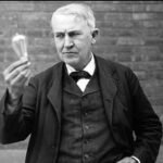 Thomas Edison with an early incandescent bulb.